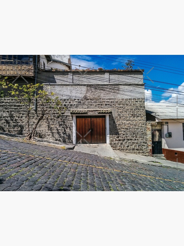 Steep cobblestone street with block house garage, Quito, Ecuador by kpander