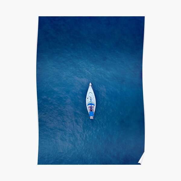 A drone shot of a sailing boat surrounded by deep blue sea water | Aerial Print Poster