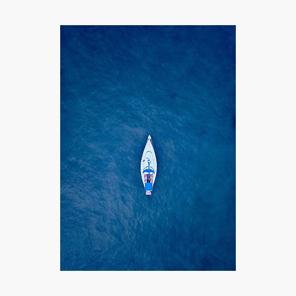 A drone shot of a sailing boat surrounded by deep blue sea water | Aerial Print Photographic Print