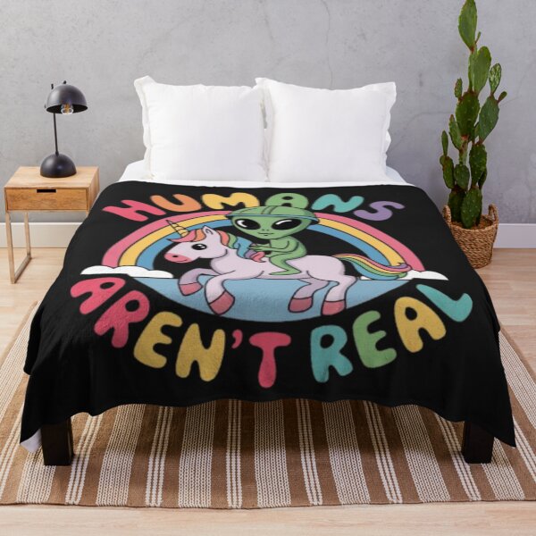 Item preview, alien riding unicorn above a rainbow with a colorful text around it " Humans aren't real " designed and sold by 123ks.