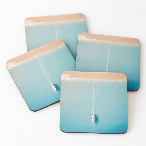 Item preview, A boat moving through clear blue waters near a sandy beach creating a trail in the water designed and sold by islamicwallart.