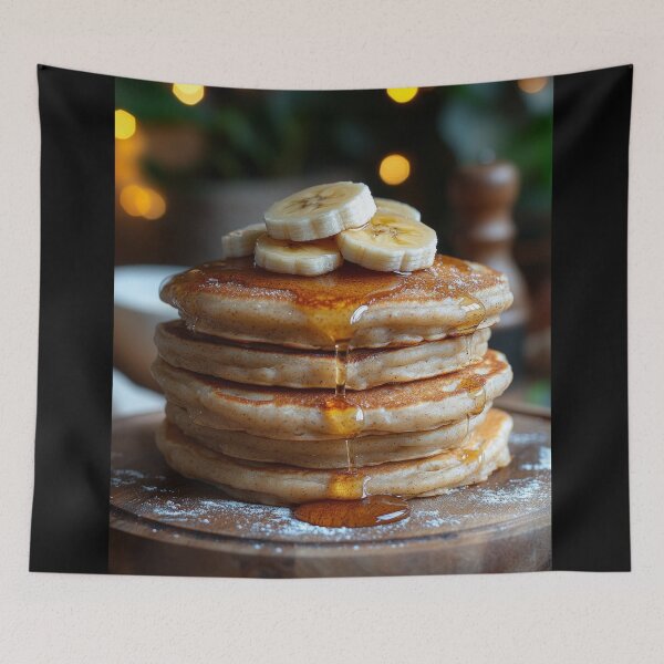 Item preview, A delicious stack of banana pancakes topped with syrup on a wooden plate, set against a warm, softly lit background. designed and sold by Jerhus.