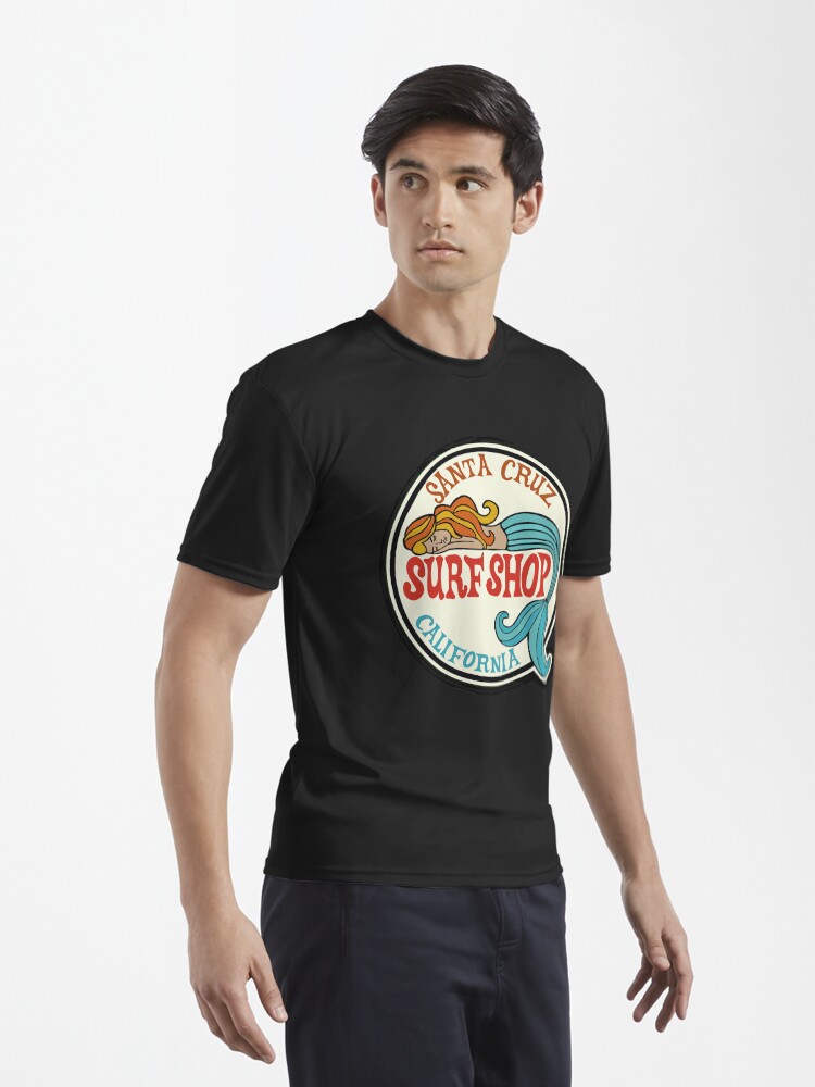 Aperçu 3 sur 7. T-shirt respirant avec l'œuvre Santa Cruz Surf Shop - Autocollant avec logo de sirène de surf vintage de Californie créée et vendue par Kludoman.