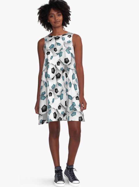 image of model wearing a cute a line dress with pattern of teal and black soccer balls