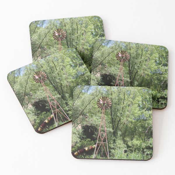 Item preview, Old fashioned metal windmill for natural energy conversion antique windmill near water and green forest behind designed and sold by Jacobs-Media.