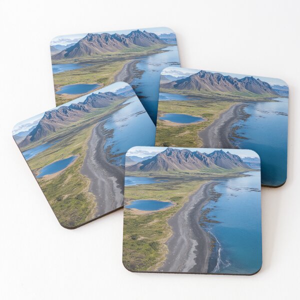 Item preview, Aerial view of a rugged coastline with mountains and calm waters on a sunny day in a remote wilderness area. designed and sold by Jerhus.