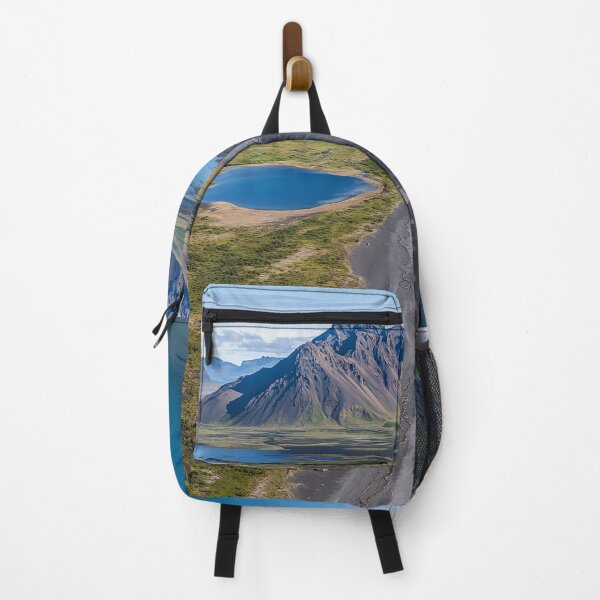 Item preview, Aerial view of a rugged coastline with mountains and calm waters on a sunny day in a remote wilderness area. designed and sold by Jerhus.