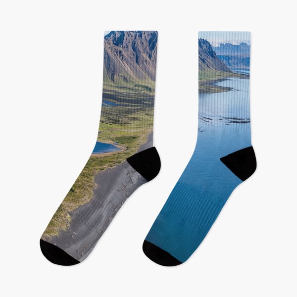 Item preview, Aerial view of a rugged coastline with mountains and calm waters on a sunny day in a remote wilderness area. designed and sold by Jerhus.