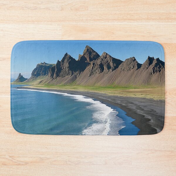 Item preview, Spectacular coastline with black sand beaches and dramatic mountains in Iceland under clear blue skies. designed and sold by Jerhus.