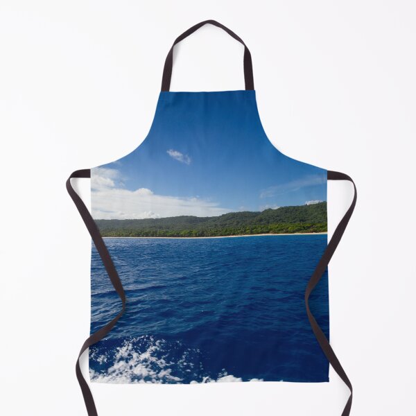 Item preview, A vast expanse of deep blue ocean meets a lush green shoreline under a clear, bright sky designed and sold by EyezWatchin.
