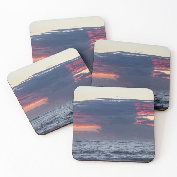 Item preview, Dark clouds stretch across the horizon during a sunrise over the ocean, with hints of vibrant red and orange designed and sold by EyezWatchin.