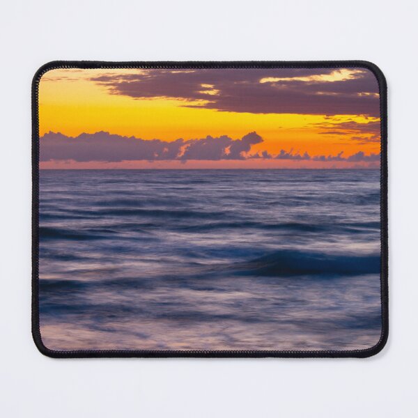 Item preview, Sunrise casts a warm glow over the ocean, blending orange and purple hues in the sky designed and sold by EyezWatchin.