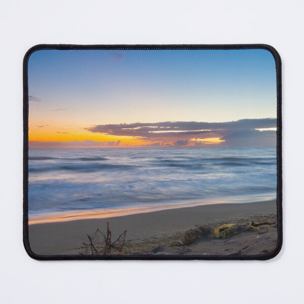 Item preview, Waves gently crash on a sandy beach as the sun rises, casting vibrant hues across the sky designed and sold by EyezWatchin.