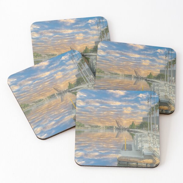 Item preview, Tampa Bay Riverwalk a serene river scene captures a reflection of the sky filled with soft clouds designed and sold by EyezWatchin.