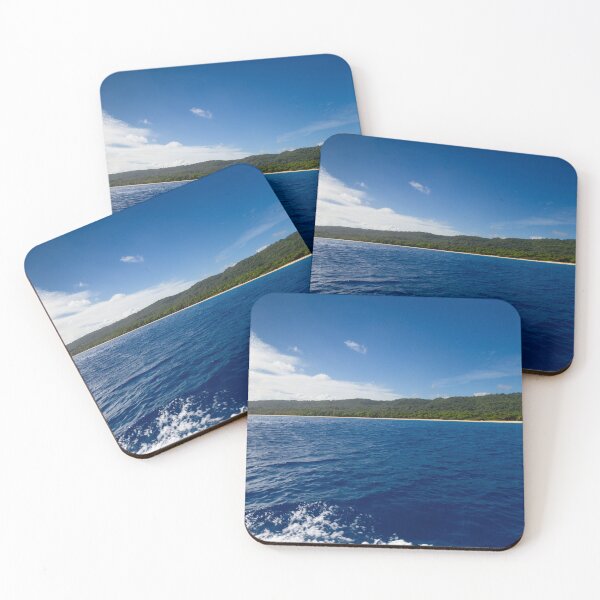 Item preview, A vast expanse of deep blue ocean meets a lush green shoreline under a clear, bright sky designed and sold by EyezWatchin.