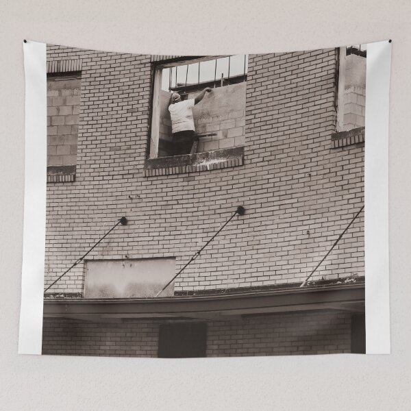 Item preview, A construction worker is working on a wall brick building viewed through an unfinished window designed and sold by EyezWatchin.
