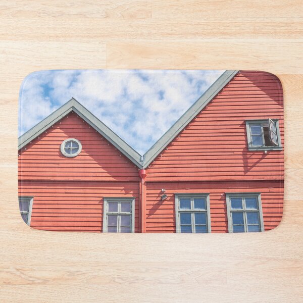 Item preview, Two world heritage houses in Bryggen in Bergen, Norway in red with a blue cloudy sky - summer street and travel photography designed and sold by Christa Stroo Photography.