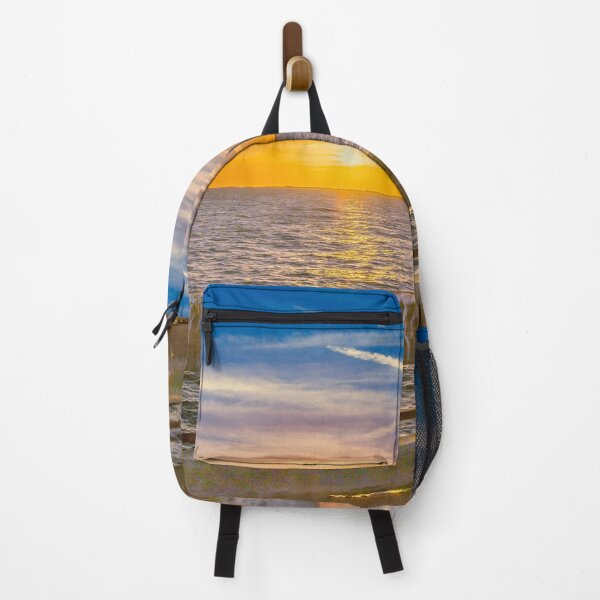 Item preview, A vibrant sunset paints the sky with warm hues of orange and yellow over a calm bay Sunshine Skyway Florida designed and sold by EyezWatchin.