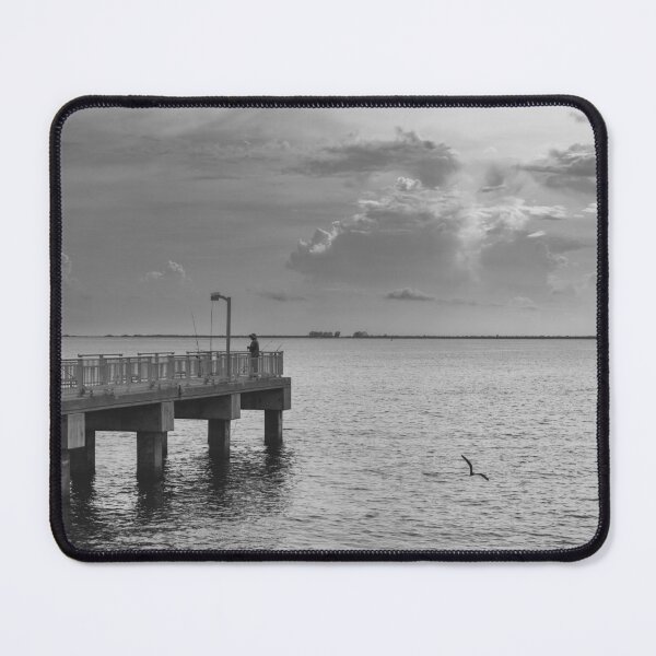 Item preview, A lone figure stands on a pier extending into a vast body of water, with dramatic clouds filling the sky designed and sold by EyezWatchin.