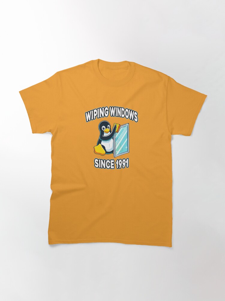 Thumbnail 3 of 7, Classic T-Shirt, Tux Wiping Windows - Linux vs Windows Tech Humor Devops Sysadmin Backend Developer designed and sold by Chengly.