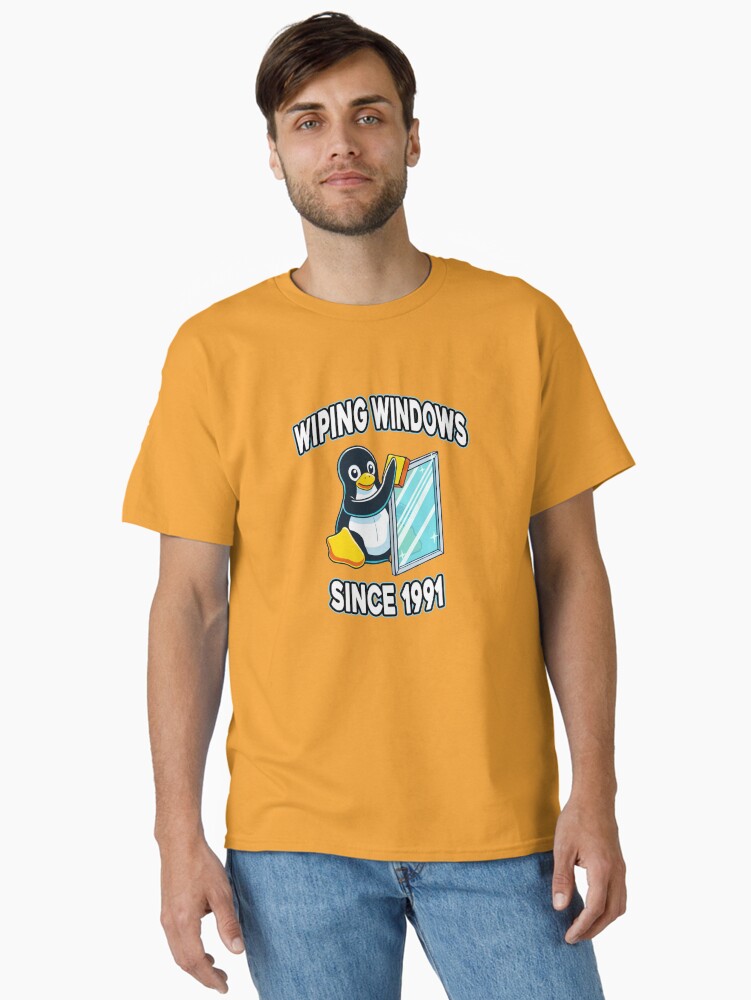 Thumbnail 1 of 7, Classic T-Shirt, Tux Wiping Windows - Linux vs Windows Tech Humor Devops Sysadmin Backend Developer designed and sold by Chengly.