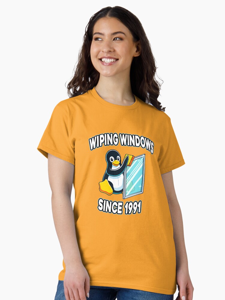 Thumbnail 2 of 7, Classic T-Shirt, Tux Wiping Windows - Linux vs Windows Tech Humor Devops Sysadmin Backend Developer designed and sold by Chengly.