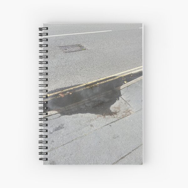 sun-bleached tarmac darkened by storm residue Spiral Notebook