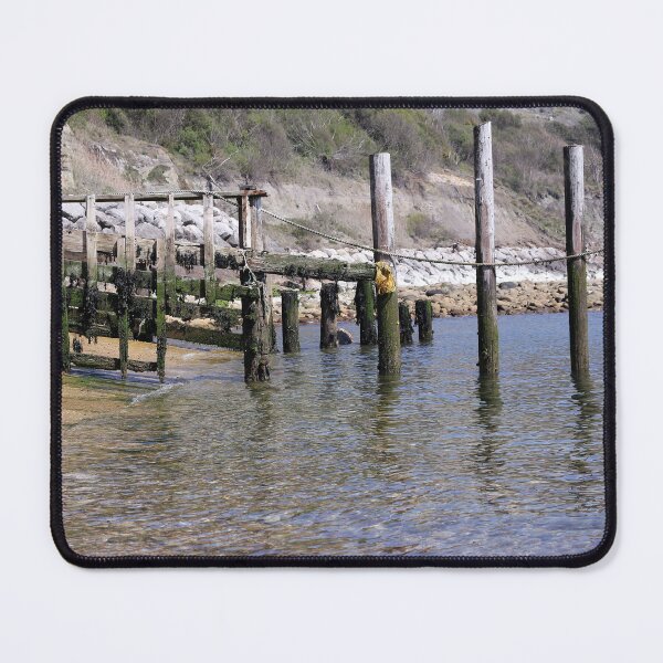 Item preview, Weathered wooden poles in the water at a rocky cove designed and sold by pinkal.