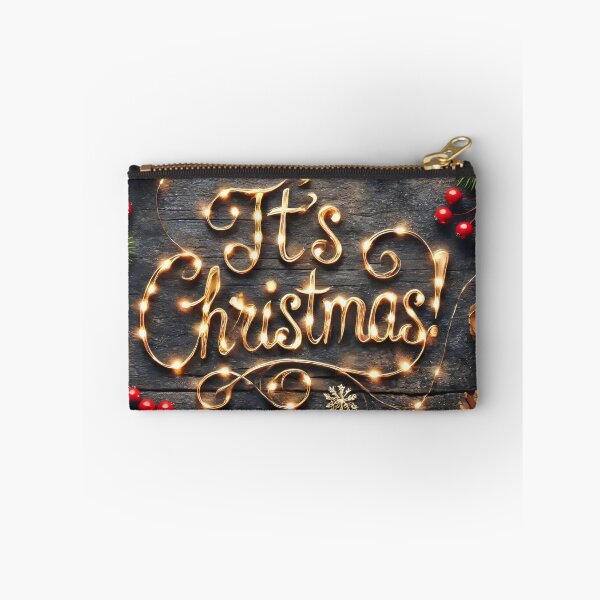 Item preview, The message "It's Christmas!" is spelled out with warm string lights, nestled among festive pine branches, pinecones, and red berries on a rustic wooden background designed and sold by homydesign.
