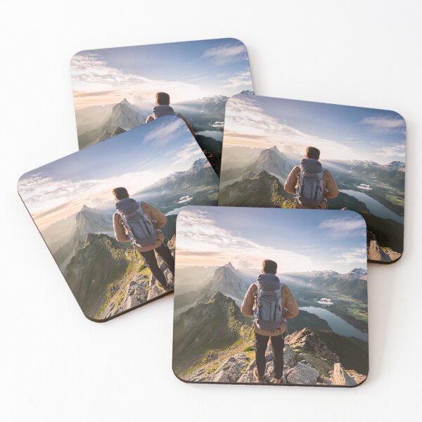 Item preview, Hiker with backpack stands atop mountain peak at sunset, overlooking dramatic alpine landscape with jagged peaks, valley lakes and sunlit clouds designed and sold by homydesign.