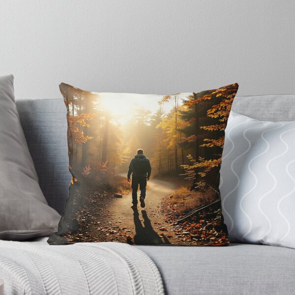 Item preview, A lone hiker walks along a winding path through a forest of vibrant autumn foliage, with golden and orange leaves illuminated by the sunlight designed and sold by homydesign.
