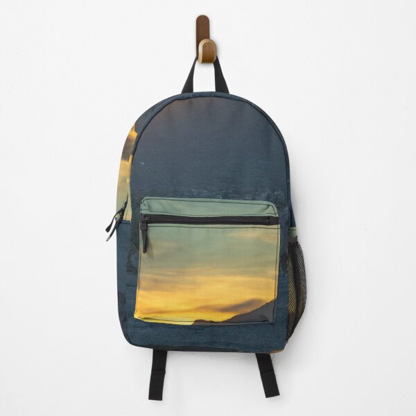 Item preview, A serene sunset casts a warm glow over a mountain range, with silhouettes of trees and rocks in the foreground designed and sold by EyezWatchin.