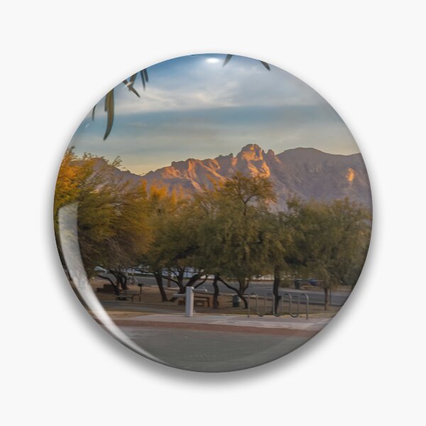 Item preview, A serene landscape captures a park at sunrise with lush green trees and majestic Catalina Mountains designed and sold by EyezWatchin.