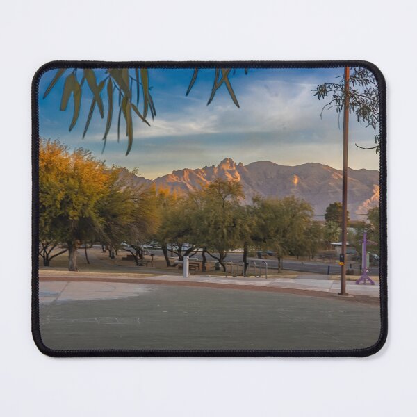 Item preview, A serene landscape captures a park at sunrise with lush green trees and majestic Catalina Mountains designed and sold by EyezWatchin.