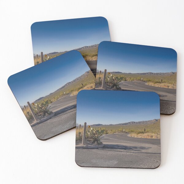 Item preview, A winding desert road curves through a landscape dotted with cacti, set against a backdrop of distant mountains under a clear blue sky designed and sold by EyezWatchin.