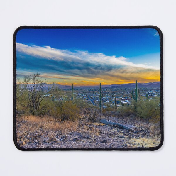 Item preview, A vast desert landscape features tall saguaro cacti under a vibrant sunset sky with wispy clouds designed and sold by EyezWatchin.