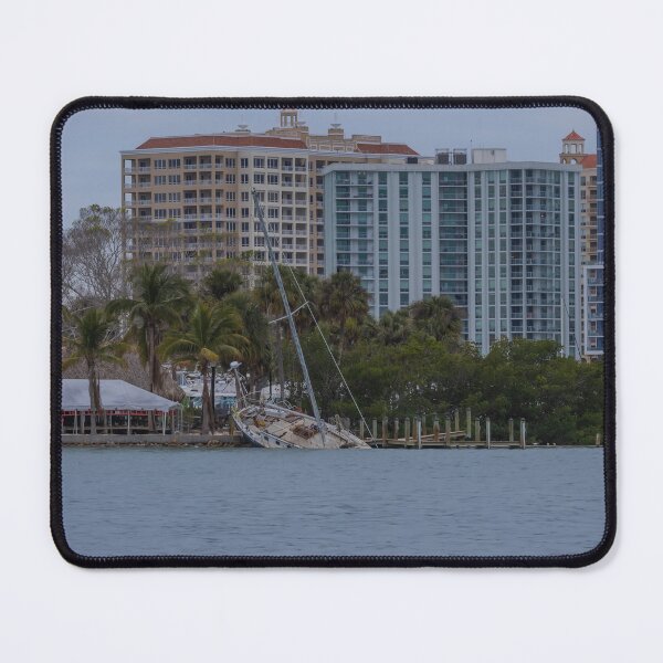 Item preview, This haunting photograph captures the aftermath of Hurricane Milton at Bayfront Park in Sarasota, Florida, with a felled boat sitting in the water, a stark reminder of the storm’s powerful impact. designed and sold by EyezWatchin.