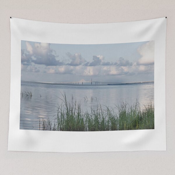 Item preview, The Sunshine Skyway Bridge Tampa Bay Pinellas County Florida is framed by tall grasses in the foreground designed and sold by EyezWatchin.