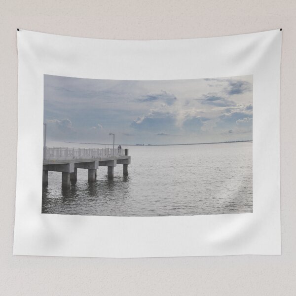 Item preview, Gulf Fishing Pier at Fort Desoto stretching out into the calm waters of Tampa Bay beneath a dramatic blue and cloudy sky designed and sold by EyezWatchin.
