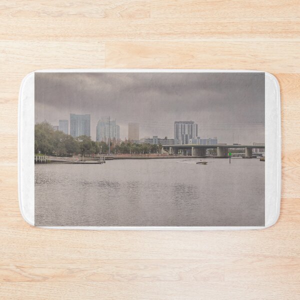Item preview, A boat glides up the Tampa Bay Riverwalk under a dramatic cloudy sky designed and sold by EyezWatchin.