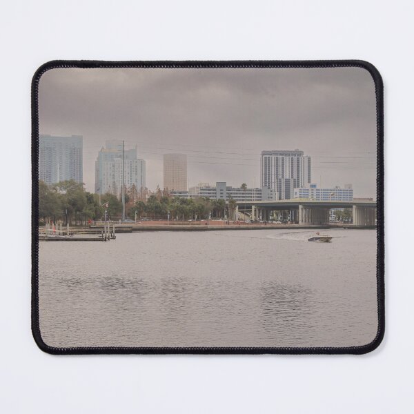 Item preview, A boat glides up the Tampa Bay Riverwalk under a dramatic cloudy sky designed and sold by EyezWatchin.