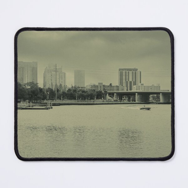 Item preview, A boat glides up the Tampa Bay Riverwalk under a dramatic cloudy sky designed and sold by EyezWatchin.