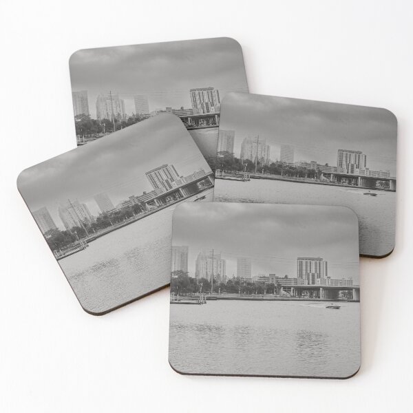 Item preview, A boat glides up the Tampa Bay Riverwalk under a dramatic cloudy sky monochrome designed and sold by EyezWatchin.