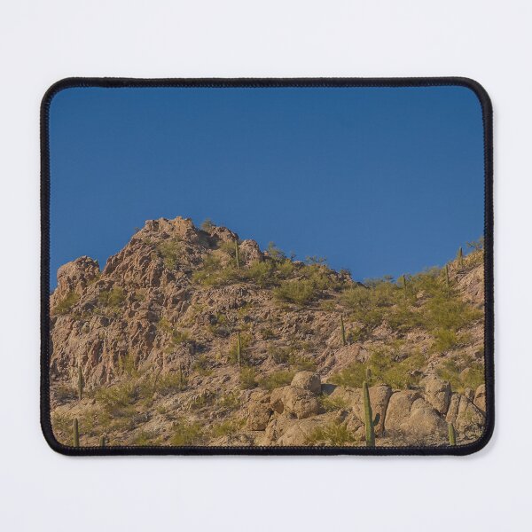 Item preview, A rugged desert landscape features rocky hills dotted with cacti under a clear blue sky designed and sold by EyezWatchin.