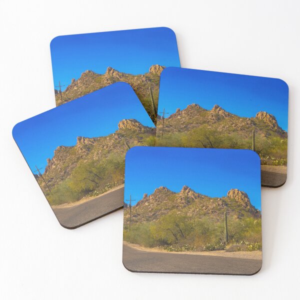 Item preview, A scenic desert landscape features rugged hills under a vibrant blue sky designed and sold by EyezWatchin.
