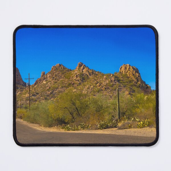 Item preview, A scenic desert landscape features rugged hills under a vibrant blue sky designed and sold by EyezWatchin.