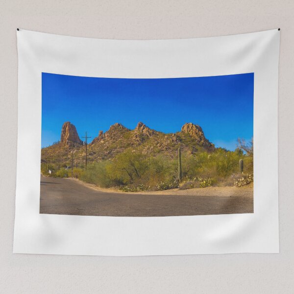 Item preview, A scenic desert landscape features rugged hills under a vibrant blue sky designed and sold by EyezWatchin.