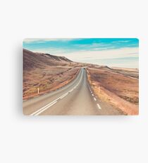 Highway through Icelandic landscape under a blue summer sky Canvas Print