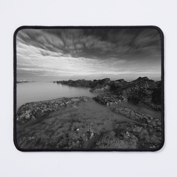 Item preview, Scenic Coastal Rock Formation Under a Vibrant Cloudy Sky in black and white designed and sold by FotoMahieu.