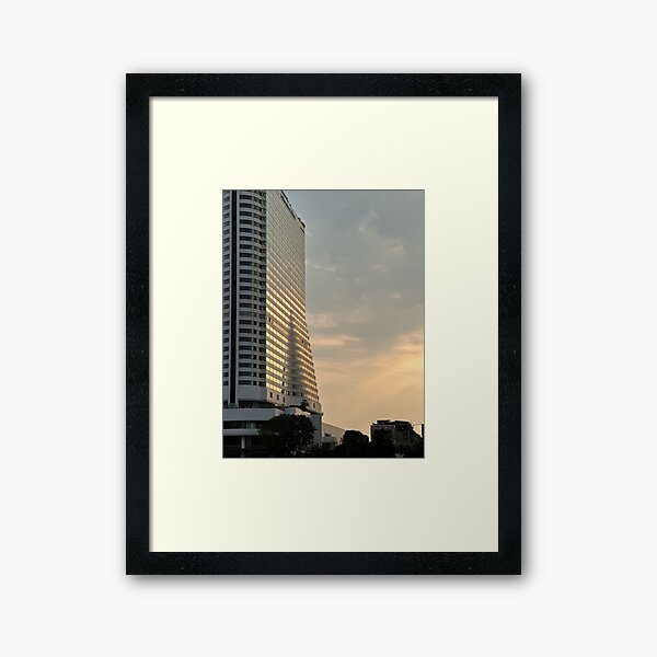 Item preview, A low-angle shot of the Millennium Hilton Bangkok hotel, illuminated by the warm light of the setting sun designed and sold by BARTISTA DESIGN.